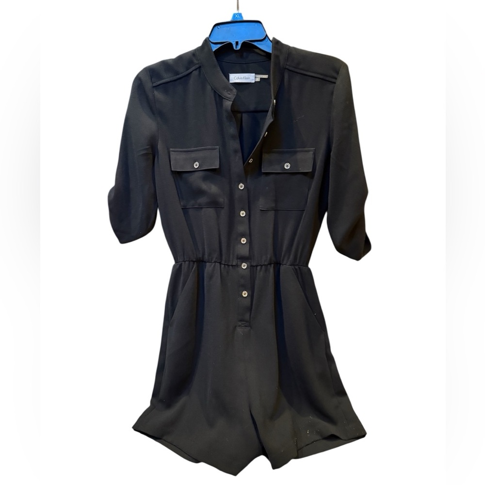 Calvin Klein Black romper with side pockets. NWOT. Size 4. Gold hardware.